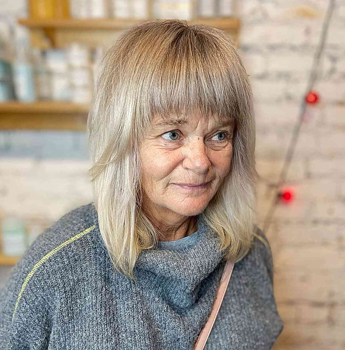 foil highlights on mid length blonde hair for women in their 60s