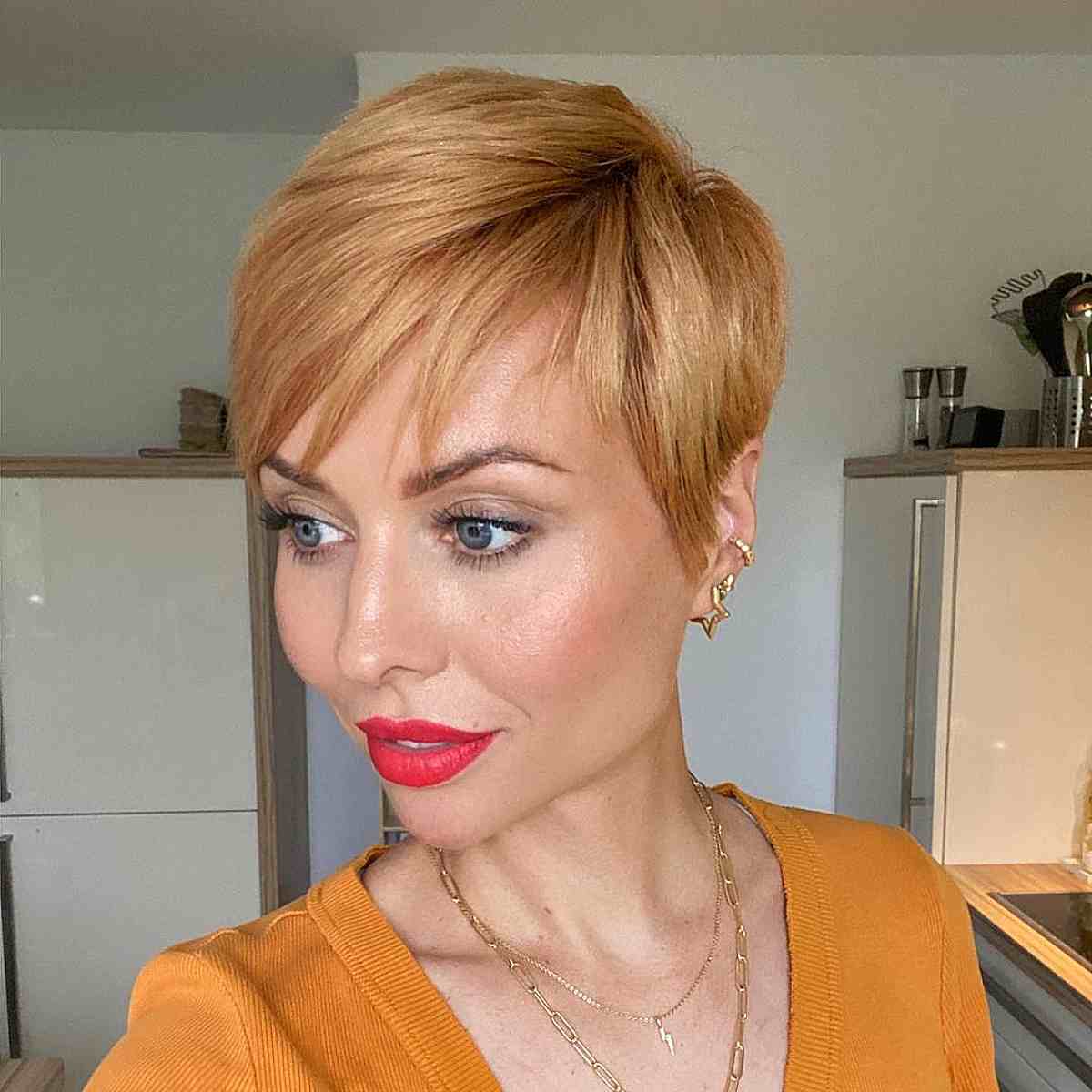 golden blonde pixie cut with side swept bangs for 40 year olds