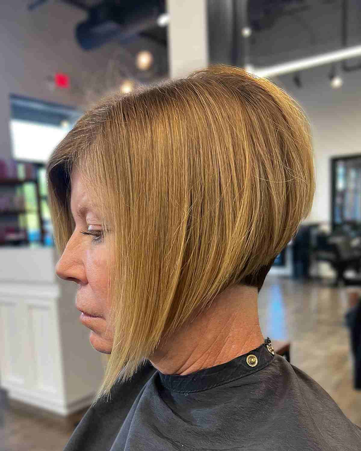 high stacked cut with a warm blonde shade