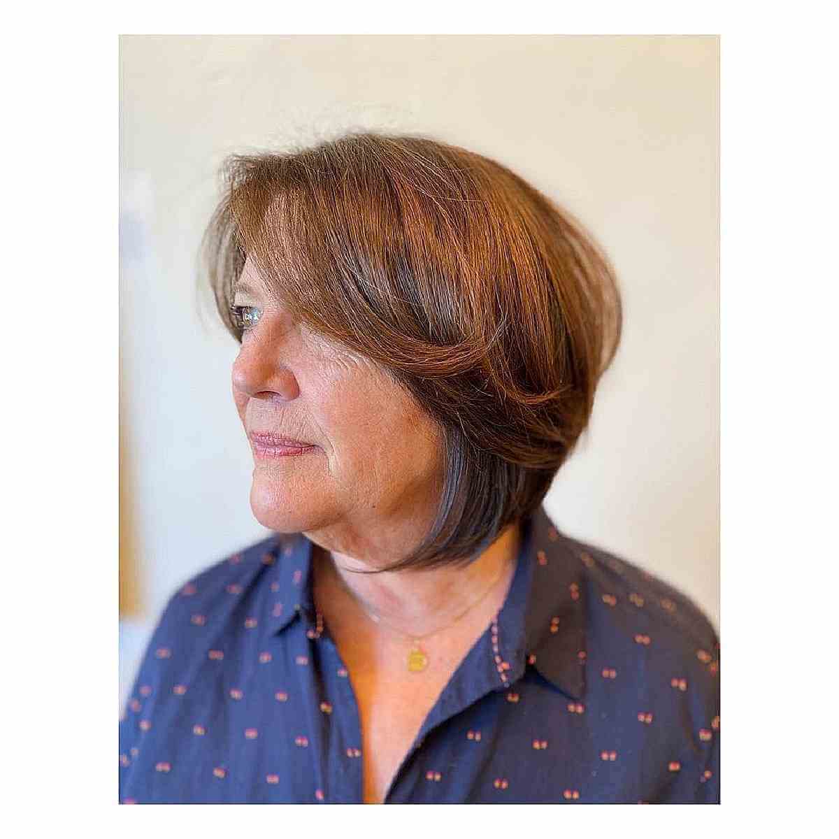 layered bob cut with side bangs for curvy woman over sixties