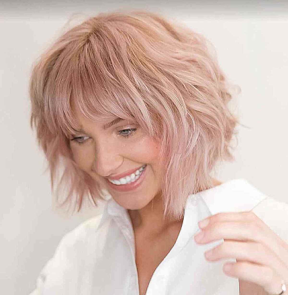layered soft pink shaggy bob with messy fringe