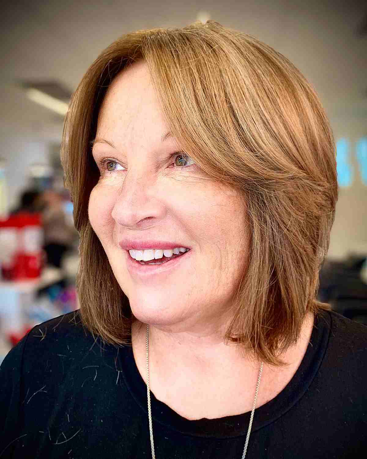 lob cut with middle part bangs and soft layers for women in their 60s