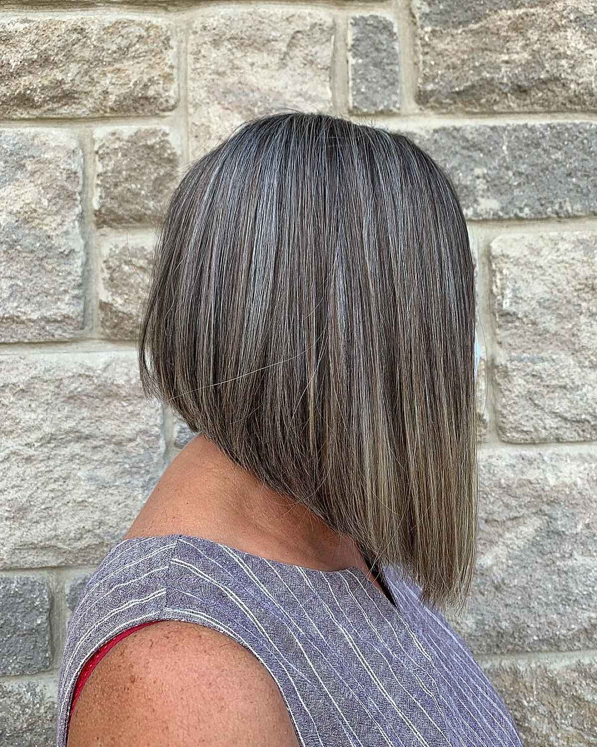 long angled bob hairstyle for a woman in her sixties