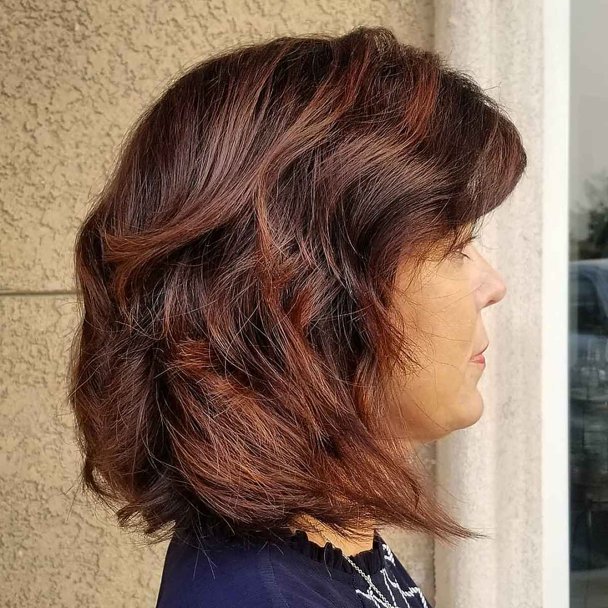 long bob with rich burgundy highlights for 60 year olds