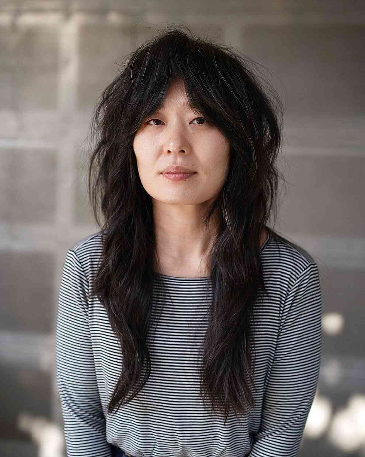 long choppy shag with curtain bangs for ladies over 40