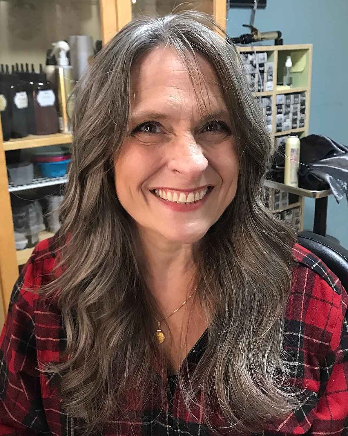 long wavy hair with center part for a woman in her 60s