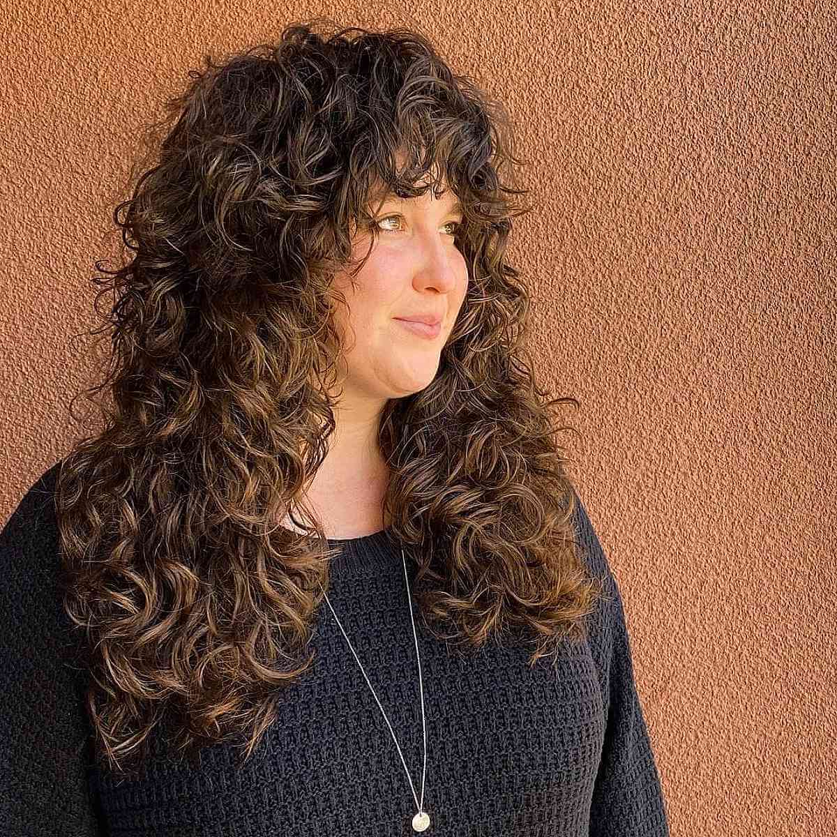 longer shagged curly hair with a fringe for girls in their 40s