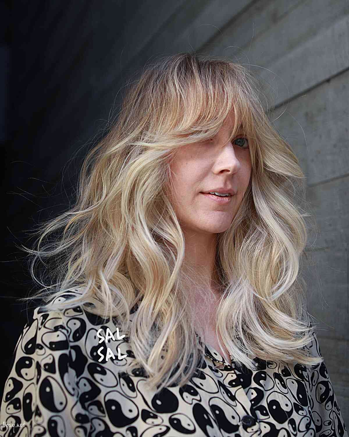 medium length thick blowout waves with curtain bangs