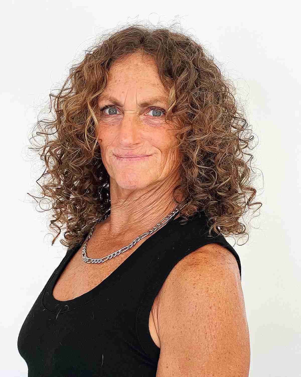 medium middle parted frizzy curls for ladies over sixty