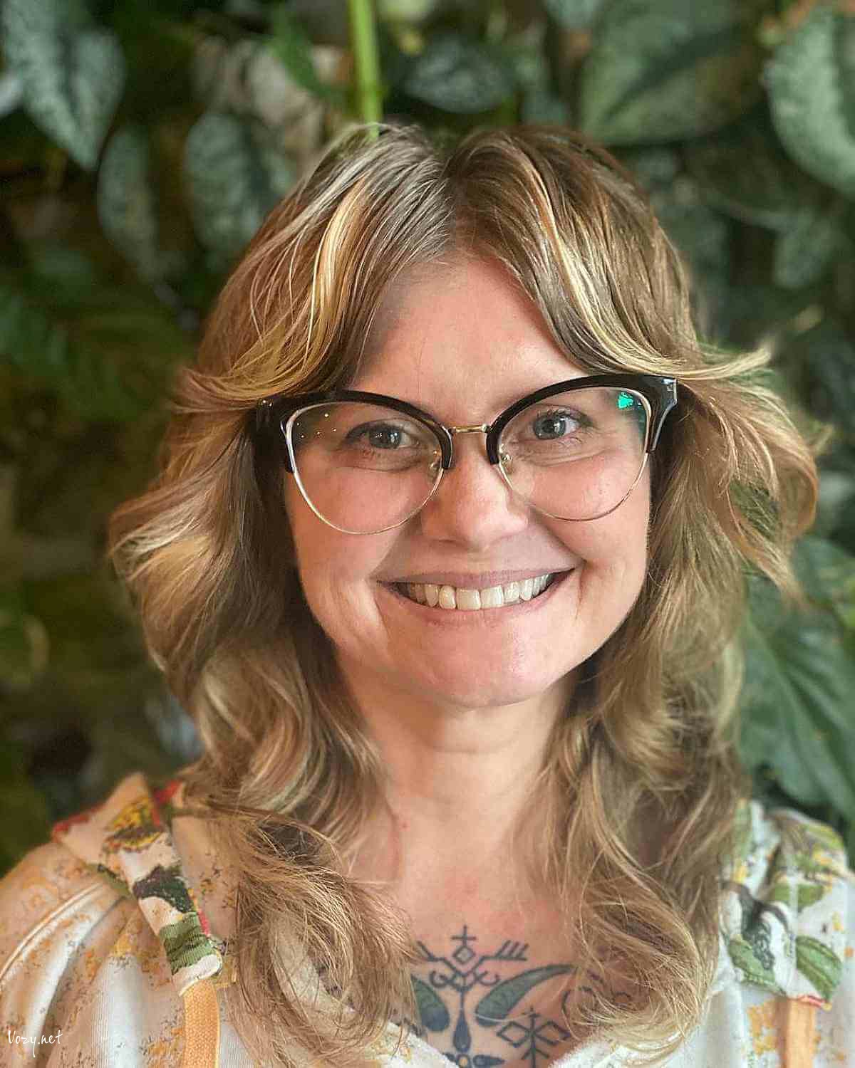 medium shag with soft curls and curtain bangs for women over 50
