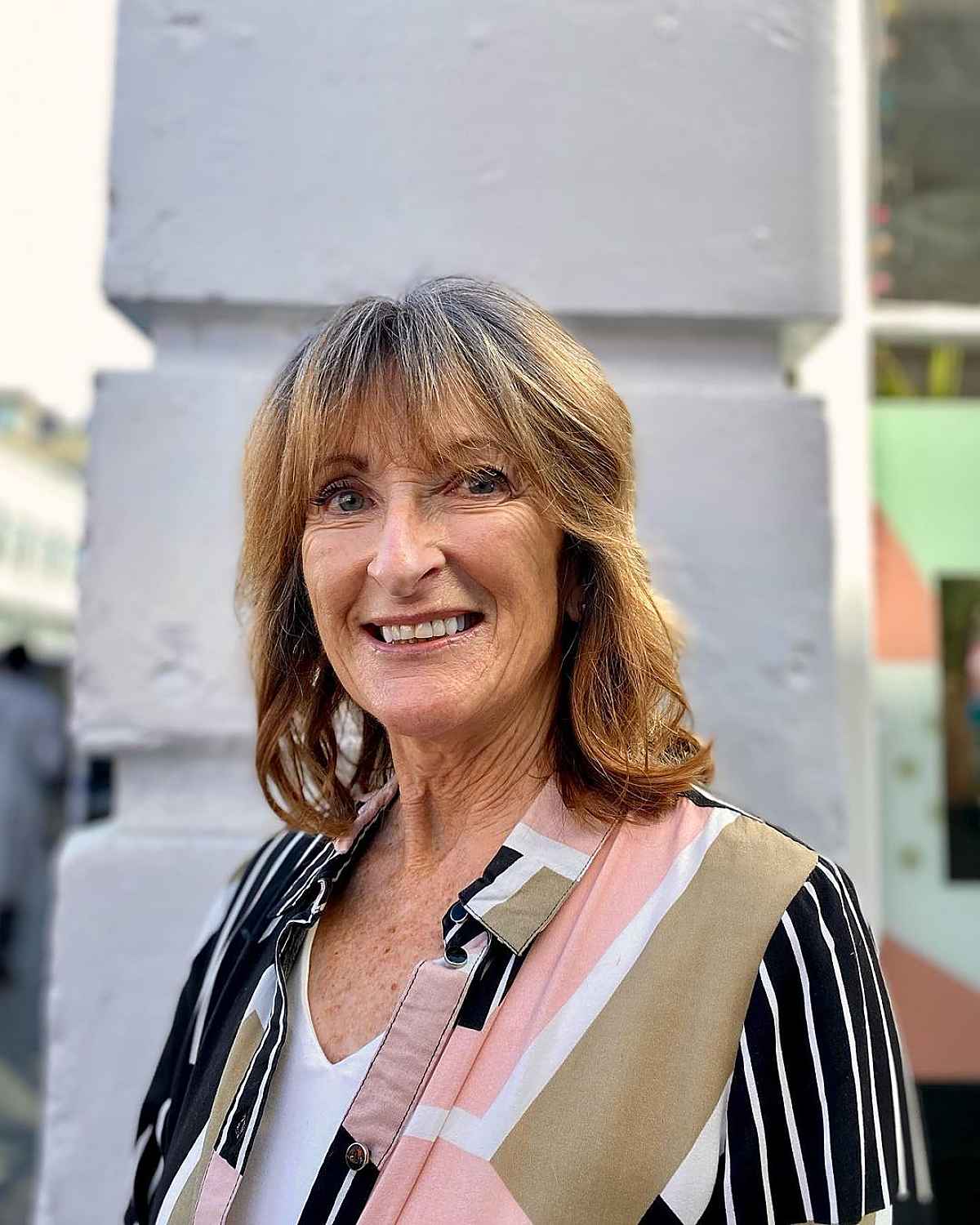 medium shaggy cut for thick hair a lady in her 60s