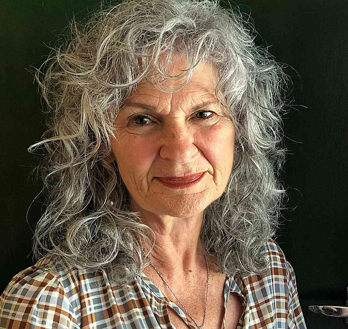 messy and frizzy curly shag for ladies in their 60s