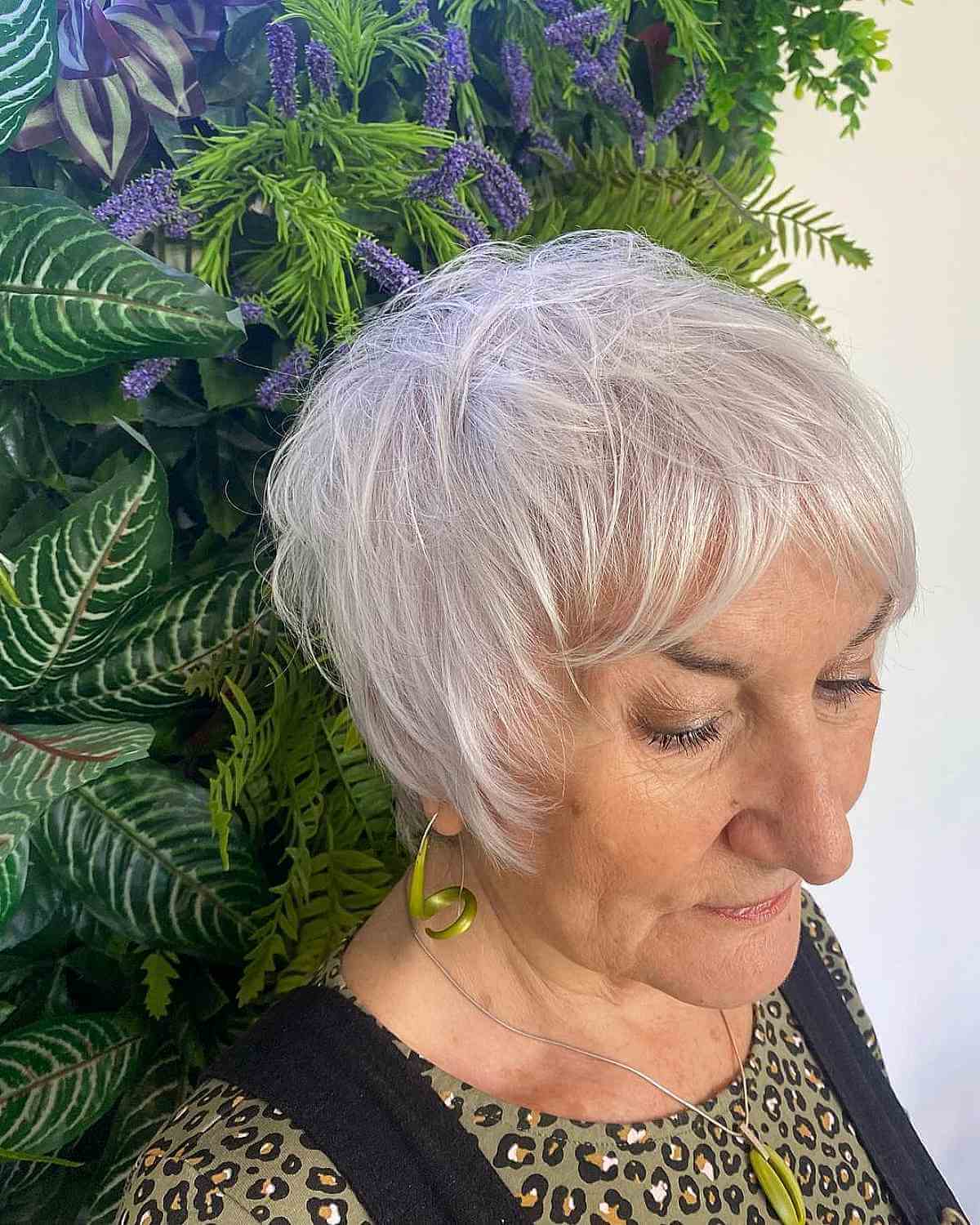 messy ear length hair with curtain bangs for 70 year old women