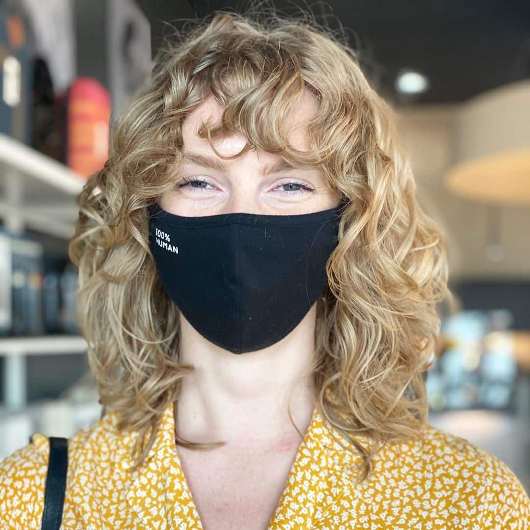 messy shaggy layered curly hair with bangs
