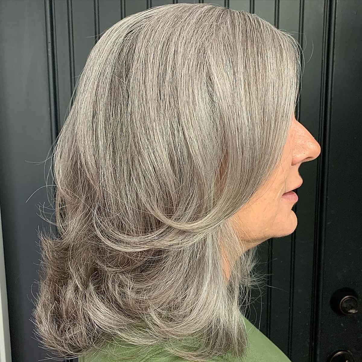 mid length cut with feathered layers for women past 60