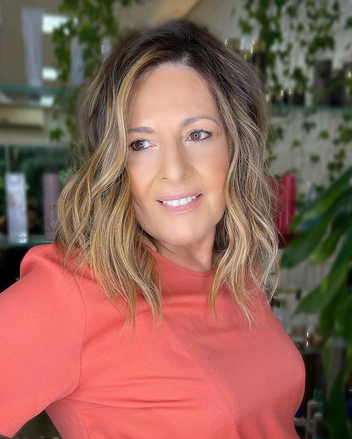 mid length layered cut with beach waves for ladies aged 60