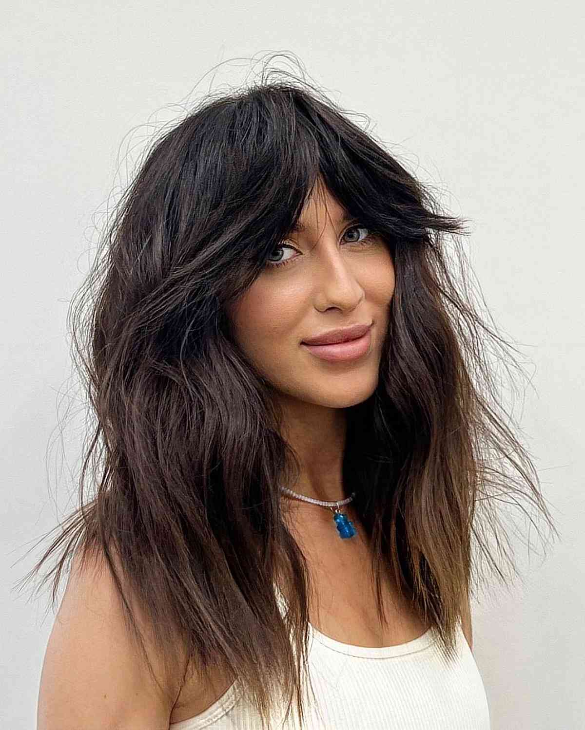 mid length shag with thick curtain bangs and layers