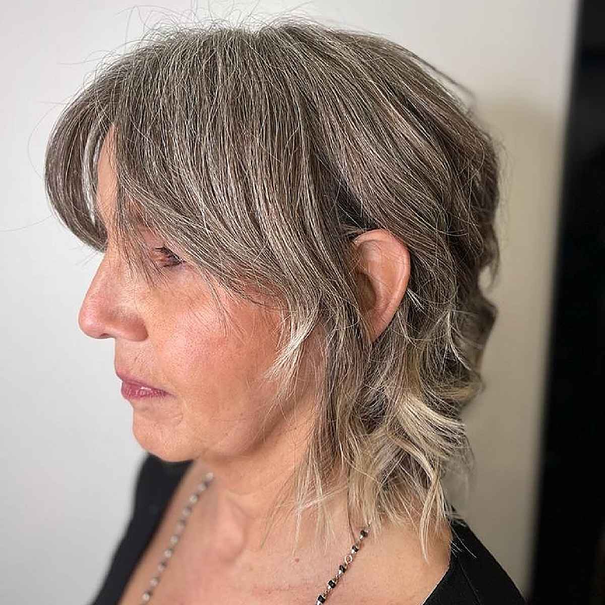 mini shaggy mullet with curtain bangs for grey hair for 60 year olds