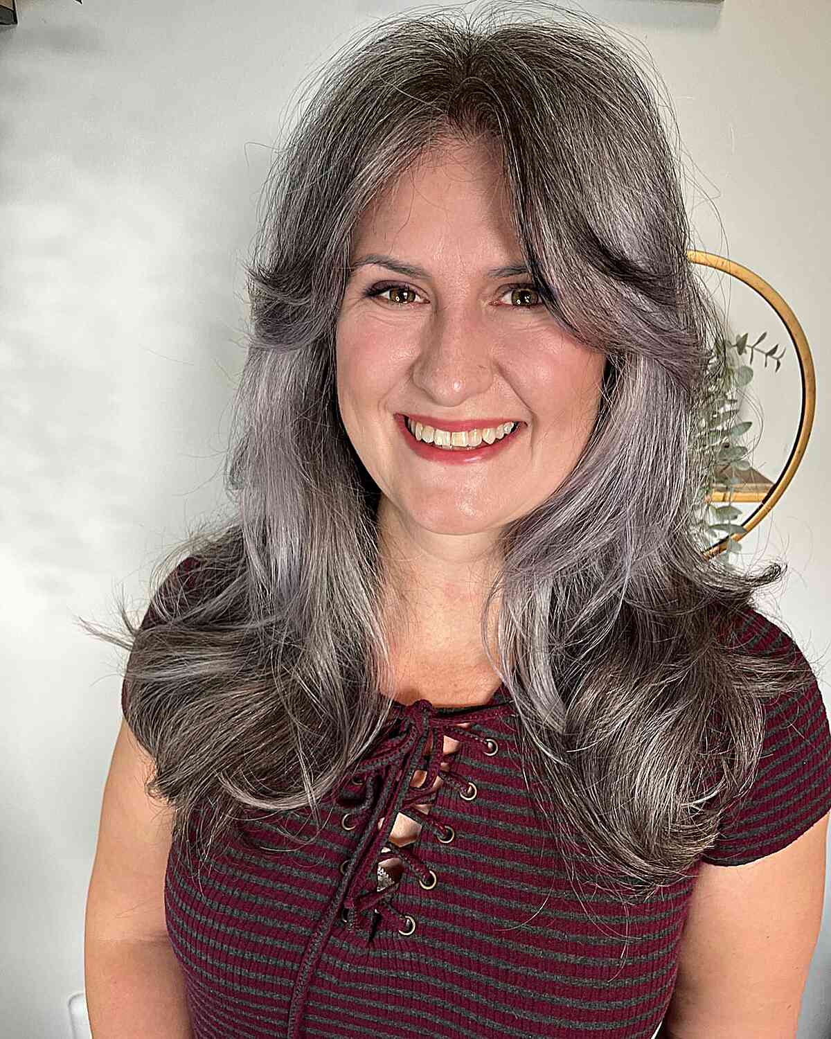 naturally salt and pepper medium haircut with long curtain bangs