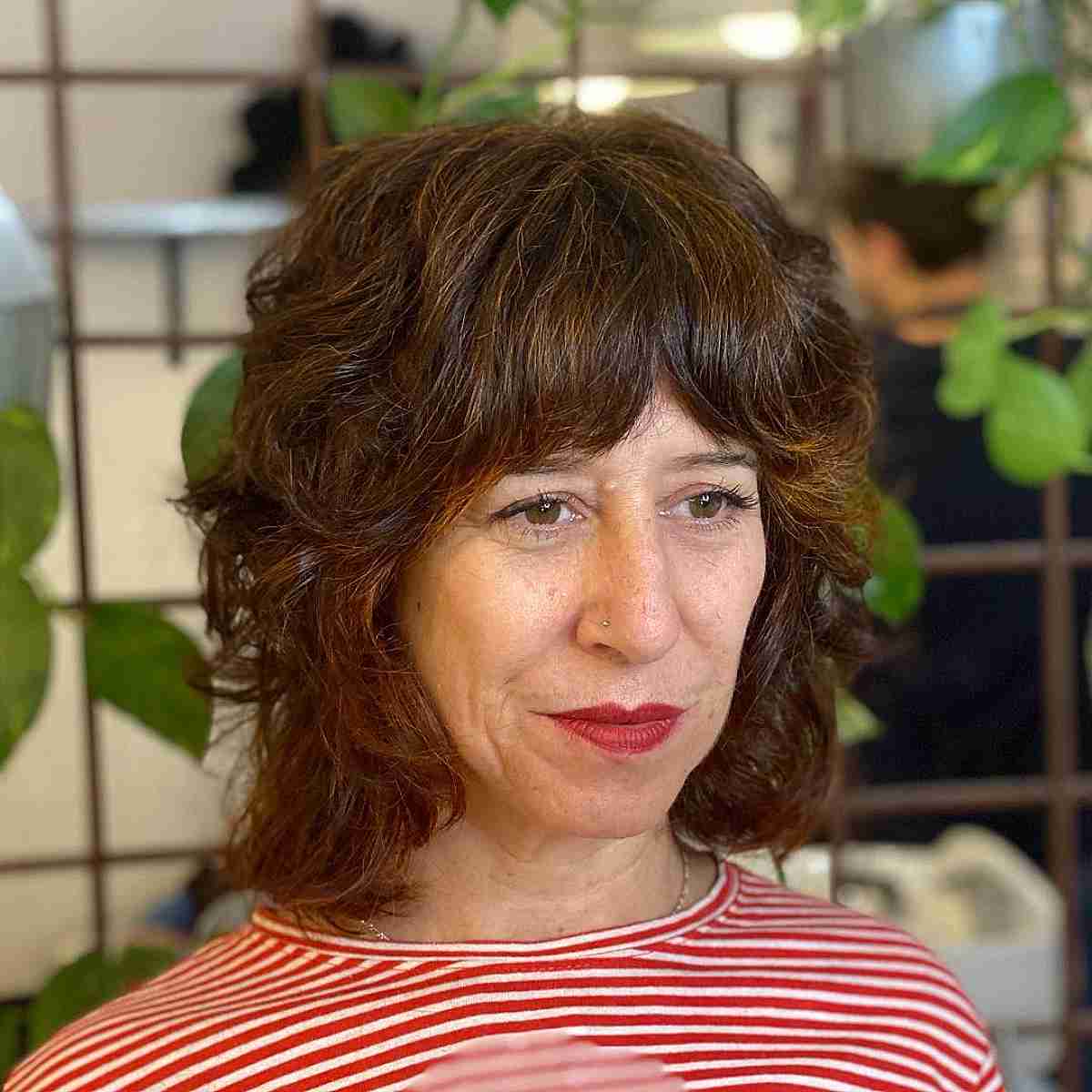 neck length shaggy bob with layers and full bangs for women over 60
