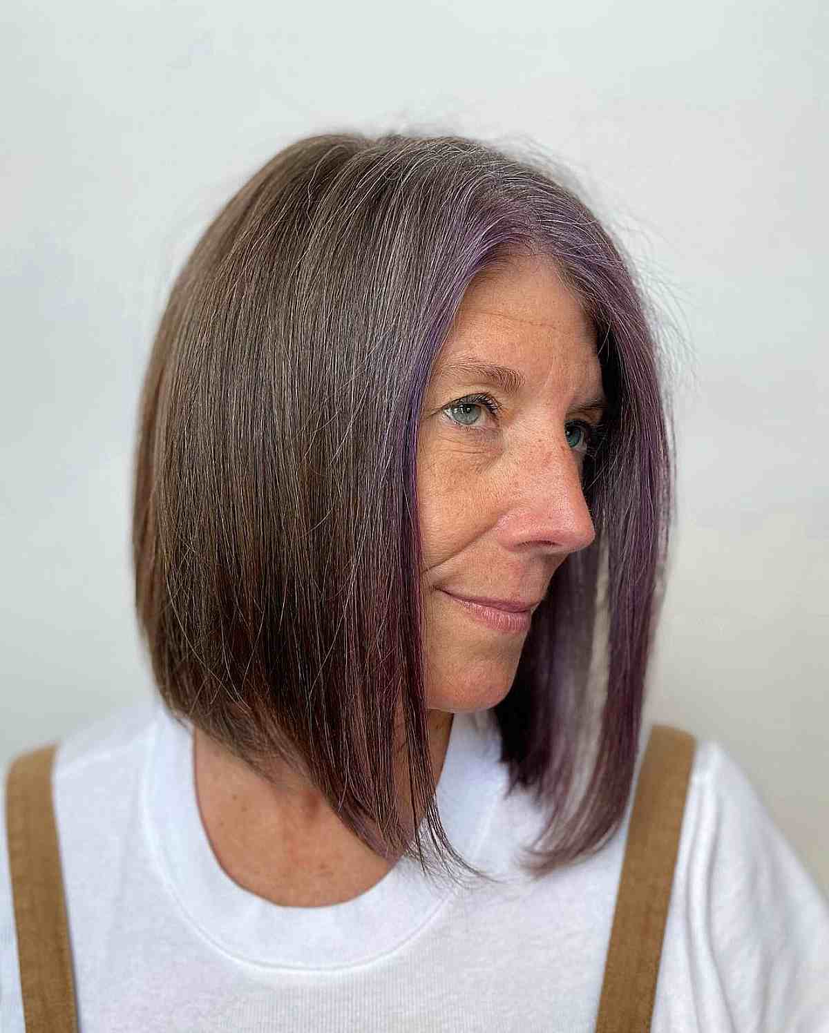 off center brunette lob with a purple money piece for old women