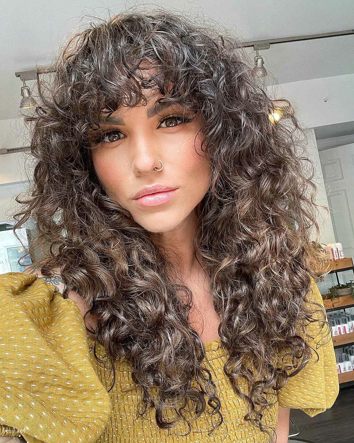 shaggy curly hair with bangs
