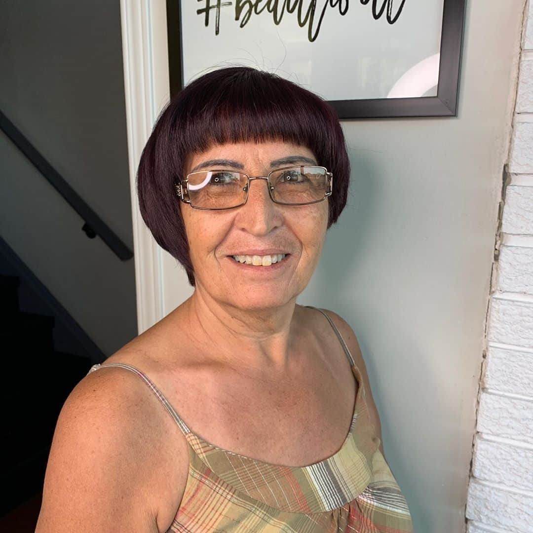 short asymmetrical bob hairstyle for over 50 with glasses
