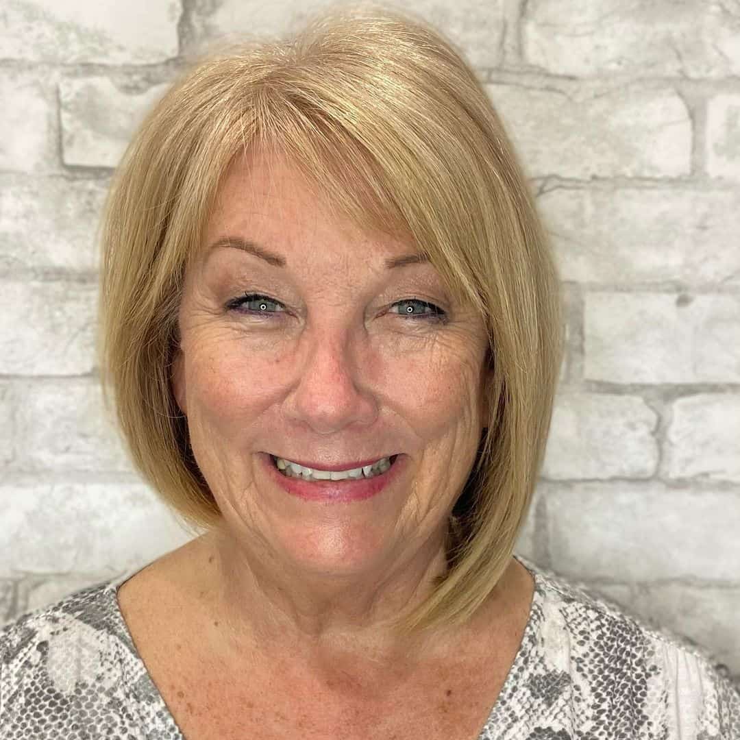 short asymmetrical bob with bangs for women over 60