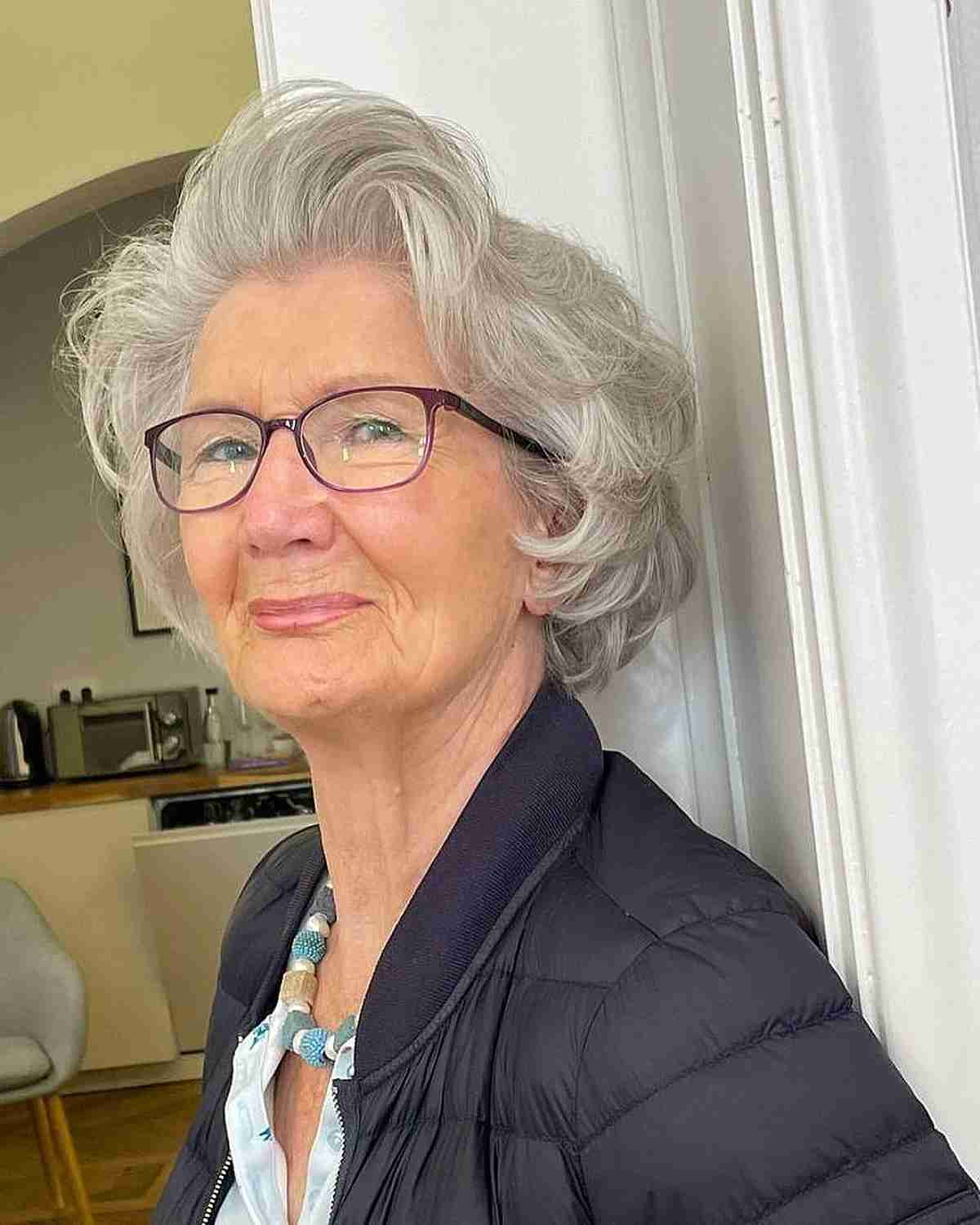short feathered cut for wavy hair with glasses for 70 year olds