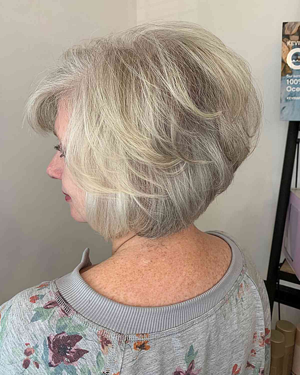 short feathered pixie bob with a line cut on ladies in their 50s