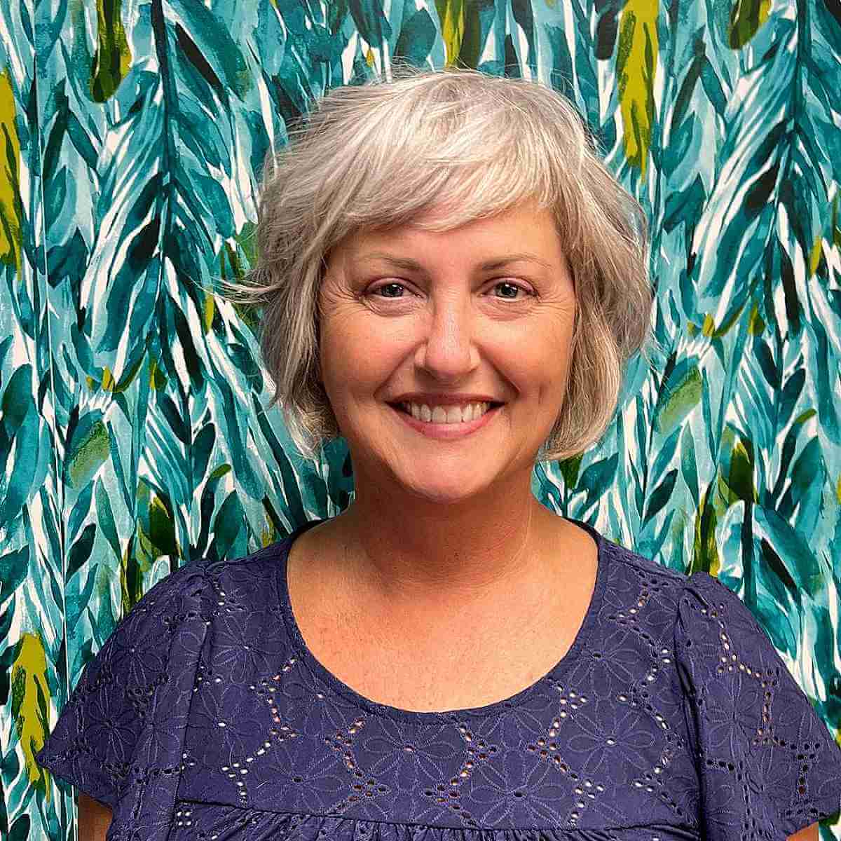 short layers and bangs on a textured bob for women over 50