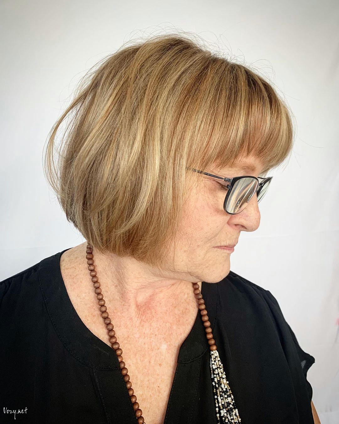 short messy bob hairstyle for over 50 with glasses