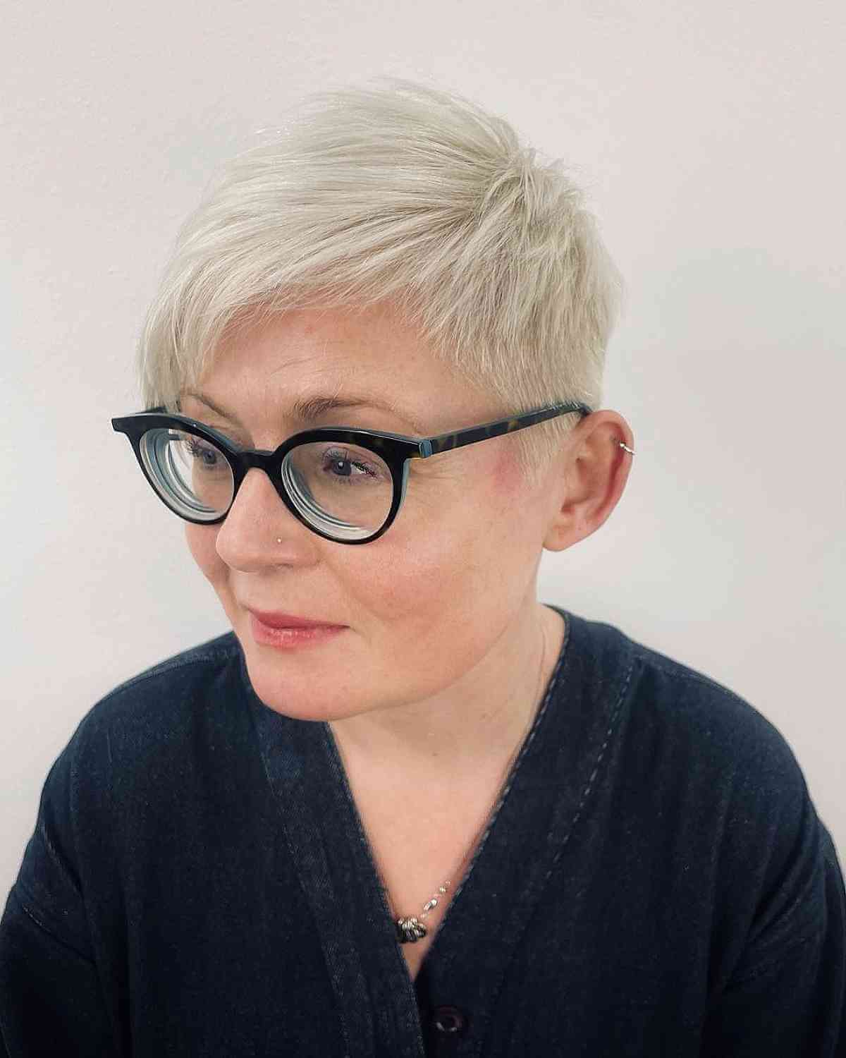 short textured pixie with long side bangs for women over 50 with glasses