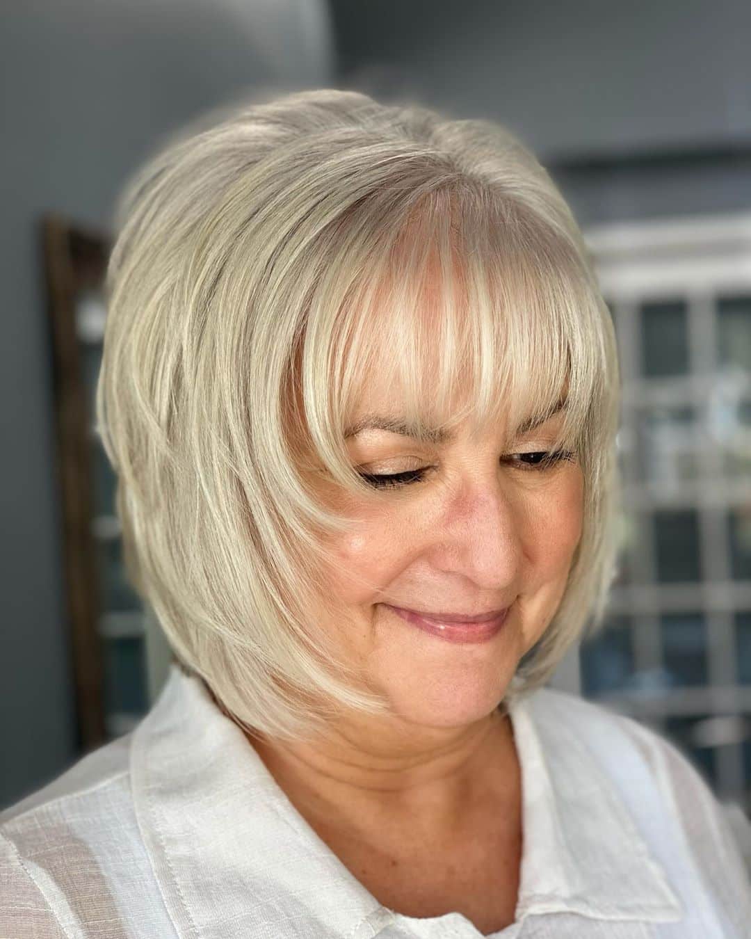 silver shaggy bob with bangs for fine haird ladies over 50