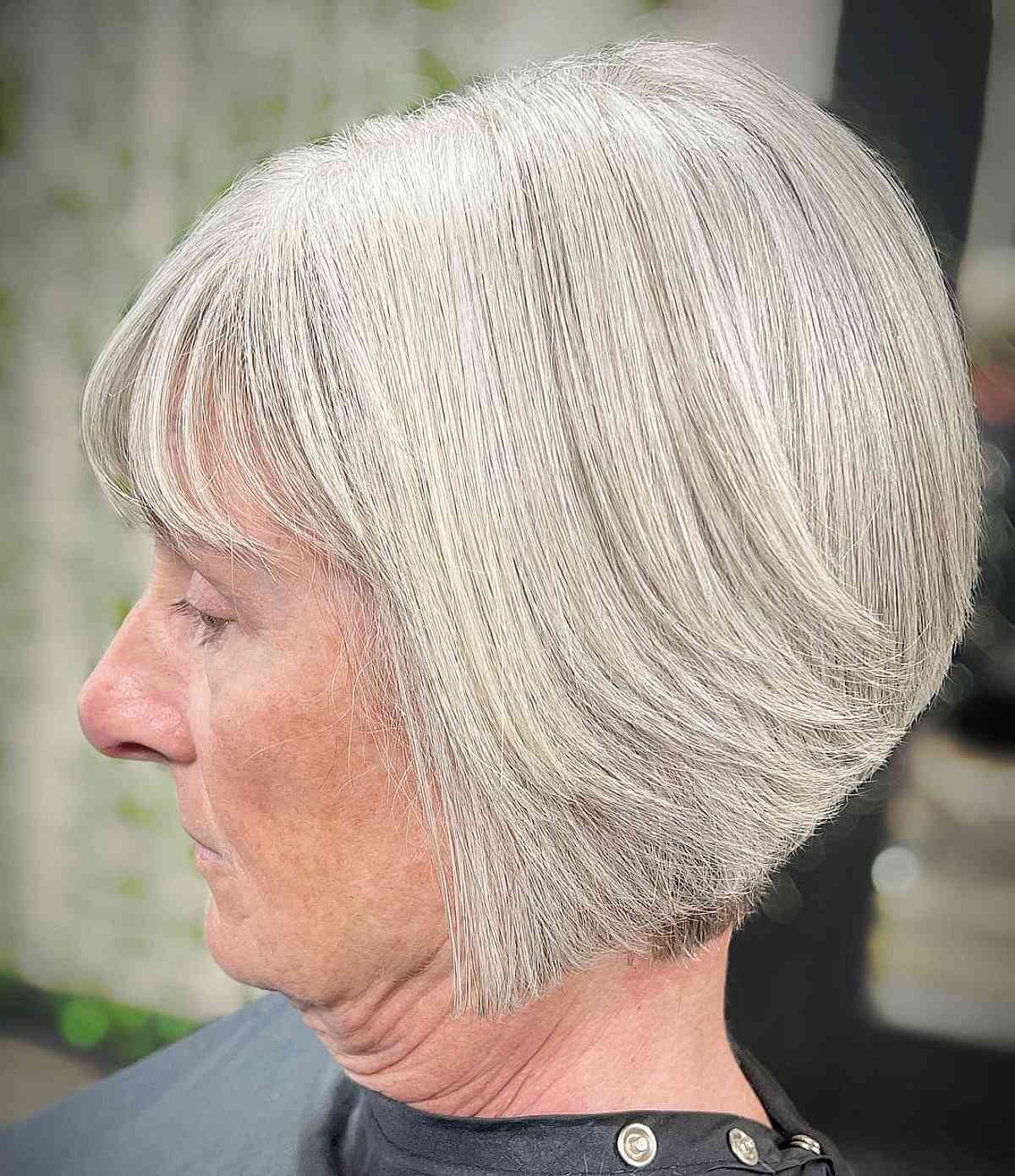 simple gray graduated bob with bangs for ladies in their 50s