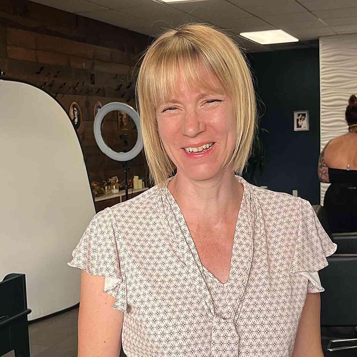 sleek blunt bob with thin bangs for ladies over 50 with short hair