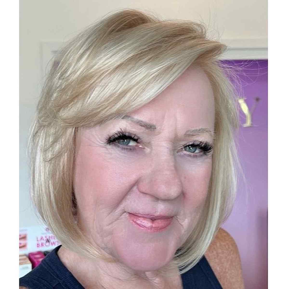 sleek chin length bob with side swept bangs for old women