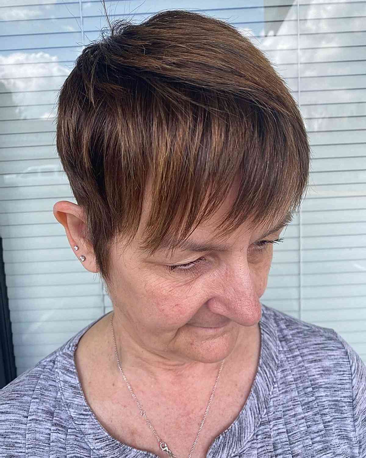 sleek pixie with bangs for a 70 year old woman