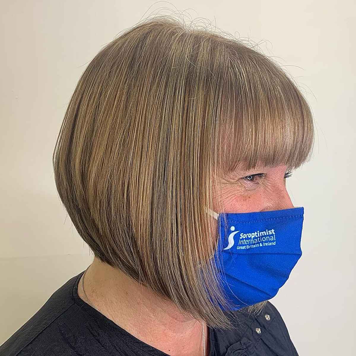 slightly angled bob with bangs for women over 60