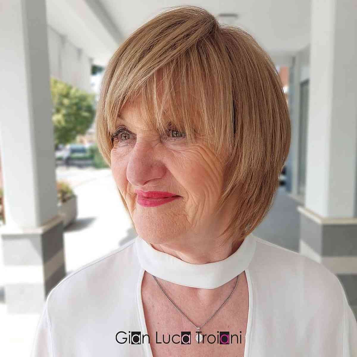 soft copper bob with side swept wispy bangs for 70 year old ladies