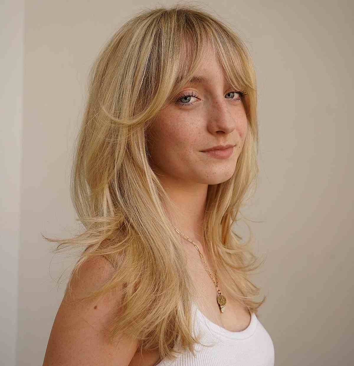 soft curtain bangs on long blonde hair