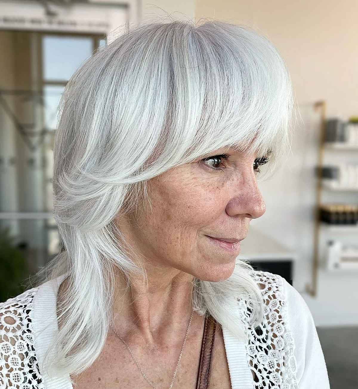 soft shag with heavy bangs for white hair for ladies over sixty