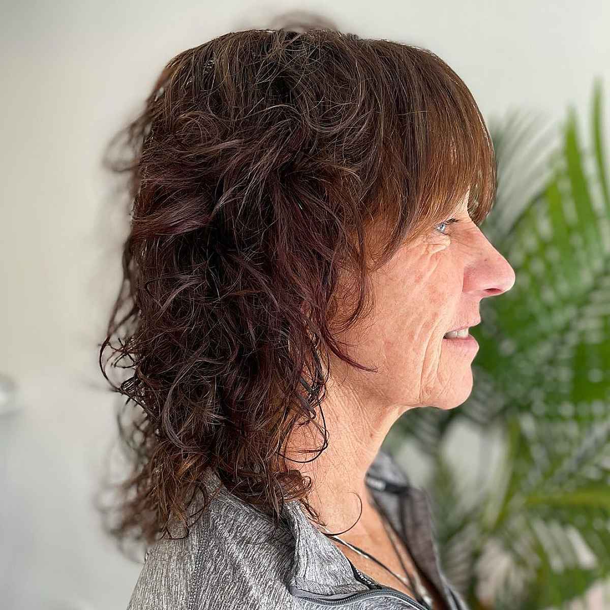 straight bangs on textured shaggy hair for ladies over 60