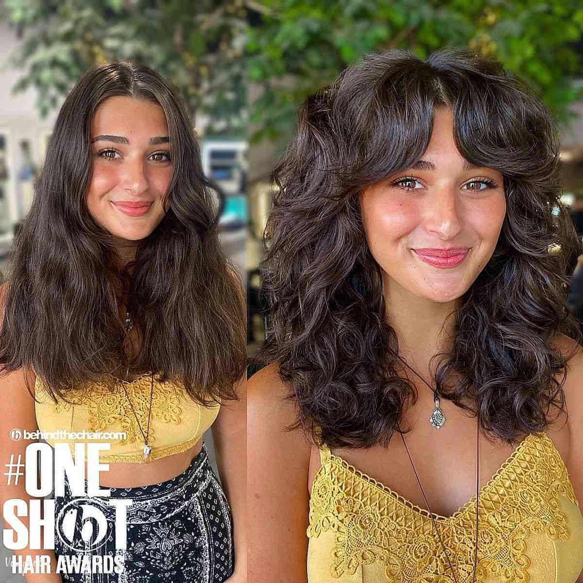 voluminous mid length loose curls with curtain bangs