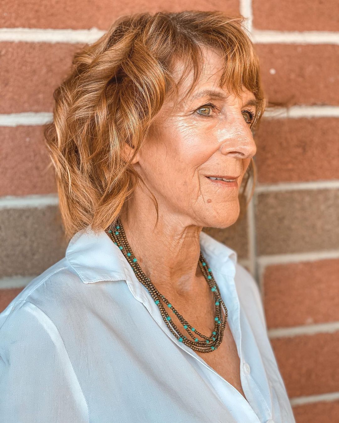 woman in her 70s with a wavy bob haircut
