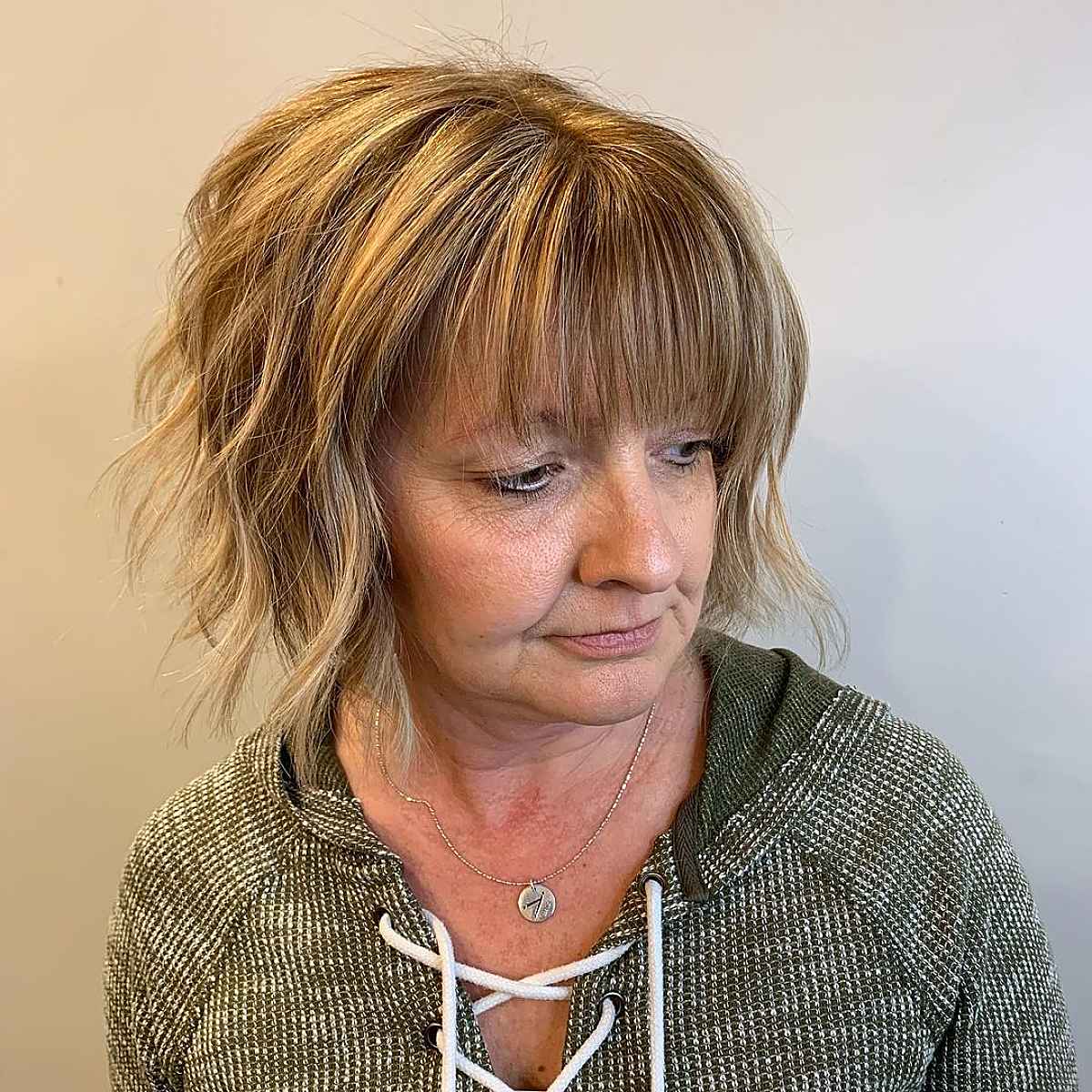 youthful bob with bangs haircut for ladies in their 60s