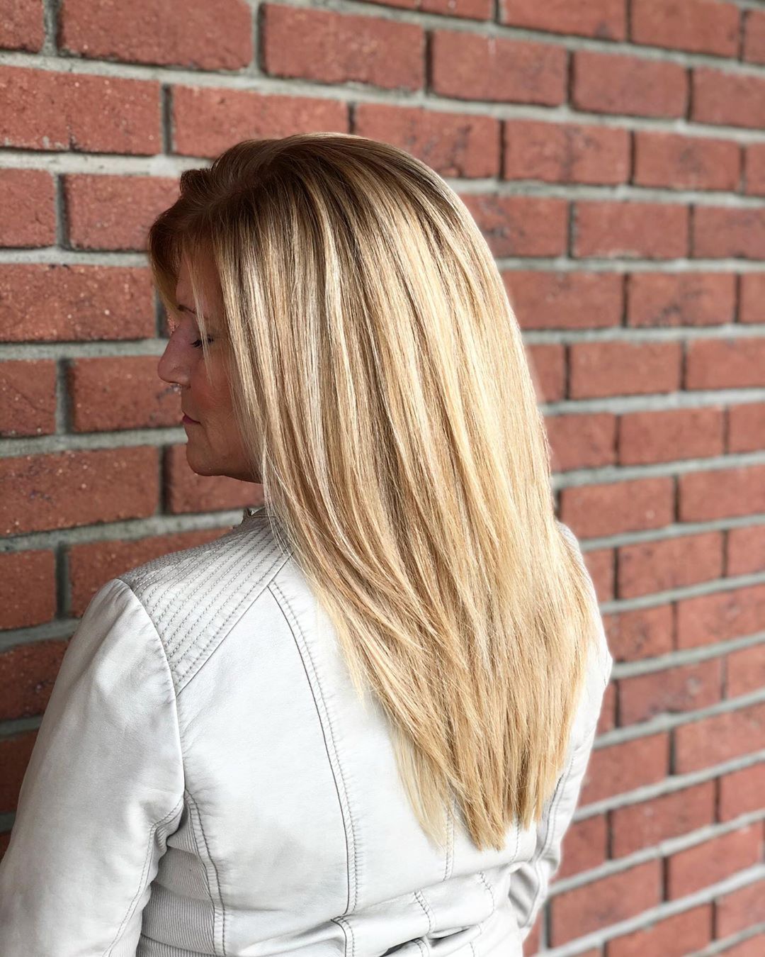 youthful bright blonde with dark roots