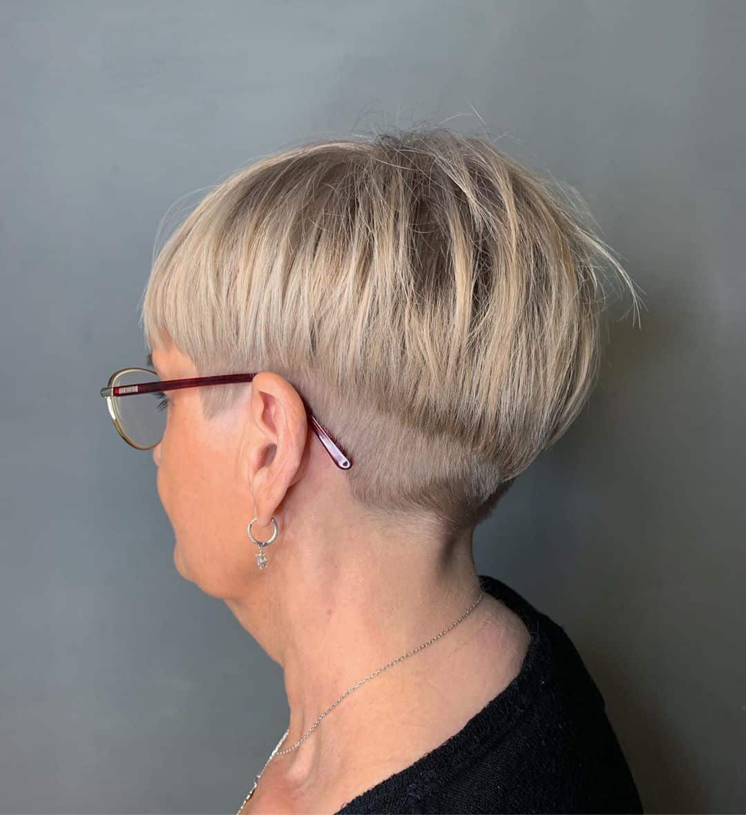 youthful short hairstyle for over 50 with glasses