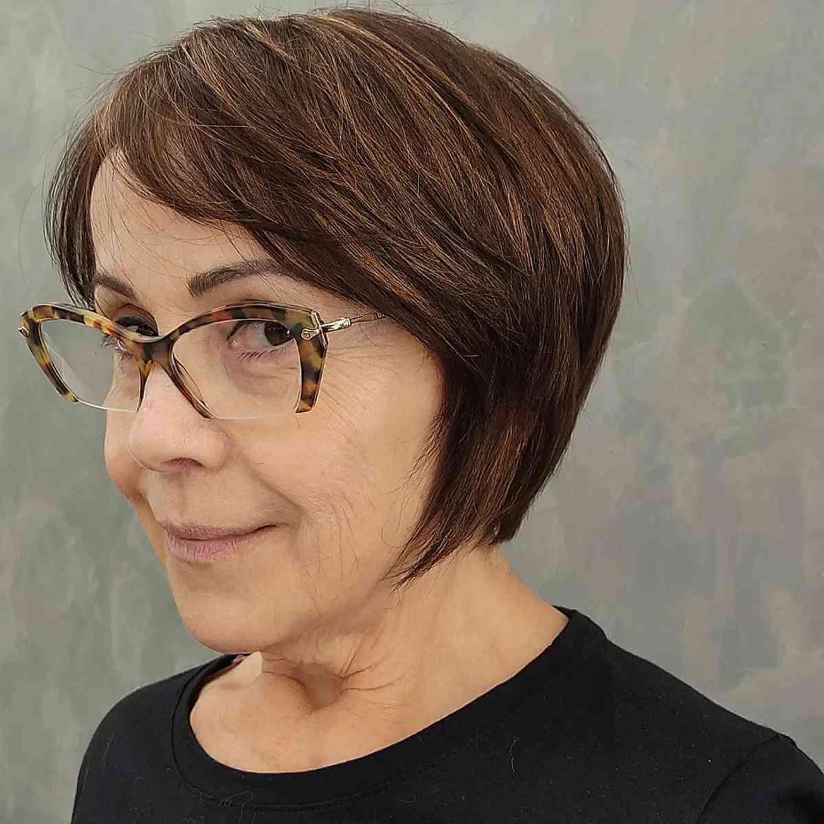 youthful side swept bob cut for a 60 year old with glasses