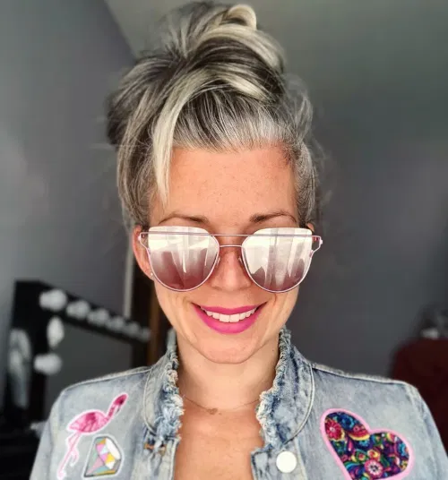 13 gray hair put into a high messy bun